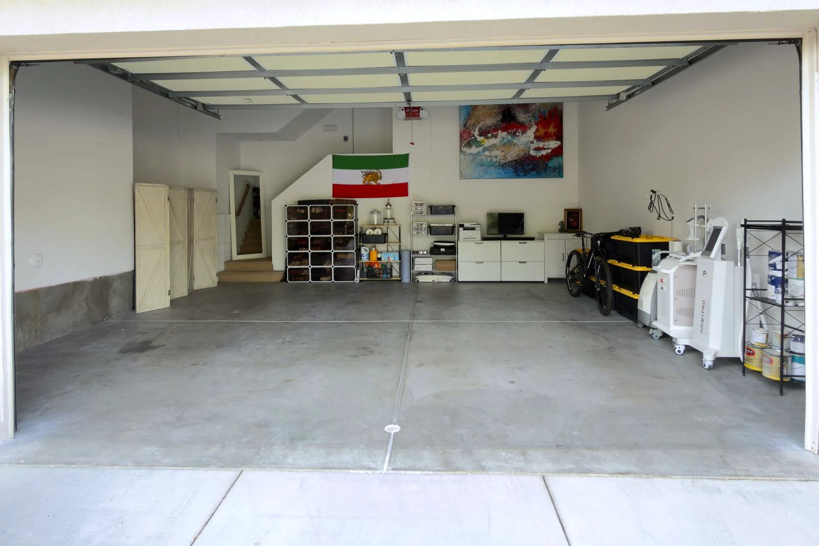 An Orange County garage after a professional declutter and organize — cleared floor, tidy storage, room to park